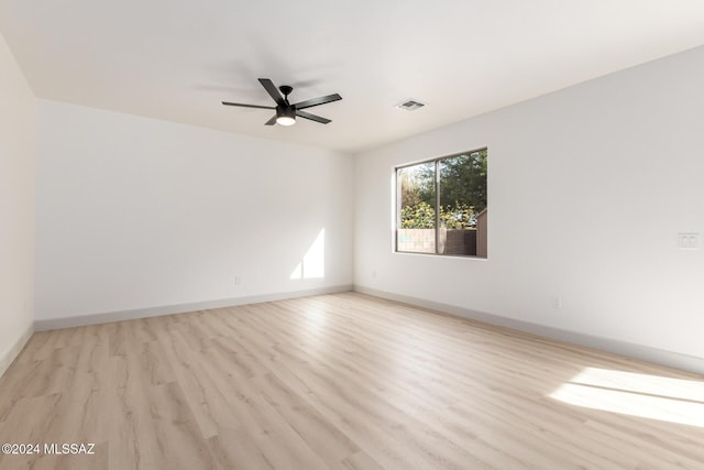 empty room with light hardwood / wood-style flooring and ceiling fan