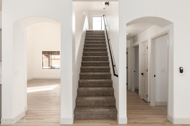 stairway featuring wood-type flooring