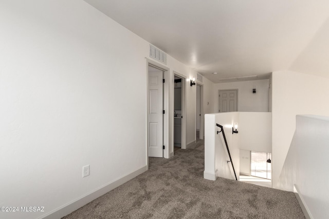 hall with light carpet and lofted ceiling