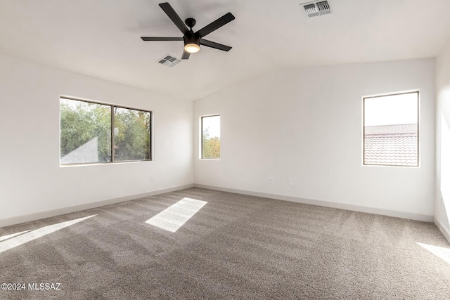 spare room featuring carpet flooring, ceiling fan, and vaulted ceiling