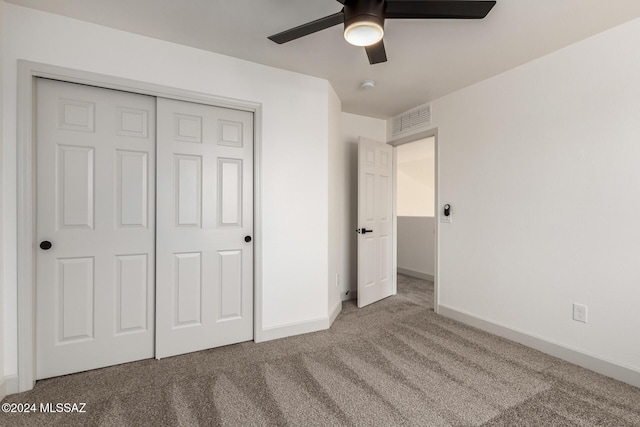 unfurnished bedroom featuring ceiling fan, carpet floors, and a closet