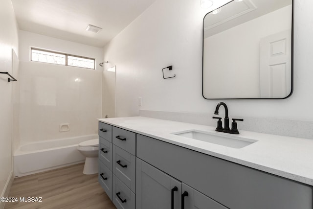 full bathroom with vanity, shower / bathing tub combination, wood-type flooring, and toilet