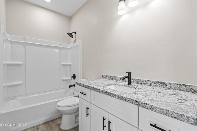 full bathroom with washtub / shower combination, hardwood / wood-style flooring, vanity, and toilet