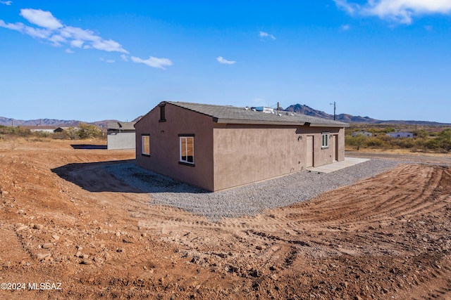 view of side of home featuring a mountain view