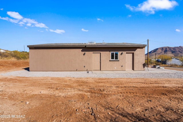 back of property featuring a mountain view