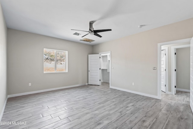 unfurnished bedroom with ceiling fan and light hardwood / wood-style flooring