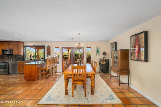 tiled dining space with a chandelier