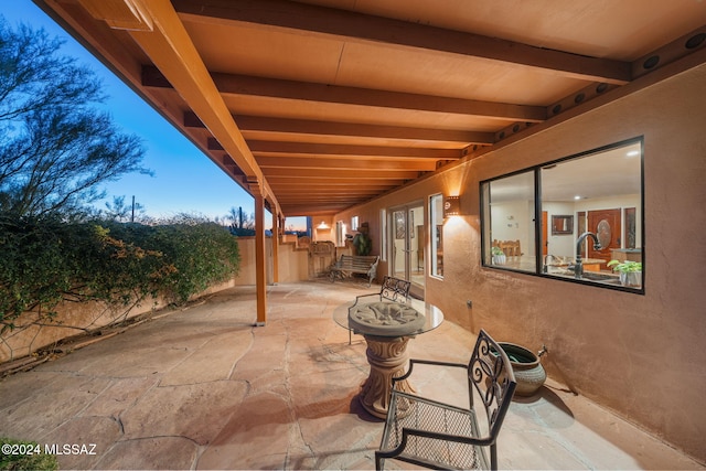 view of patio terrace at dusk