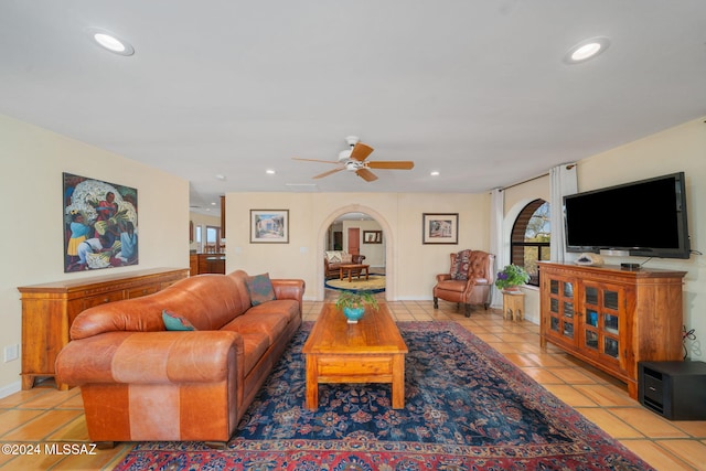 tiled living room featuring ceiling fan and a healthy amount of sunlight