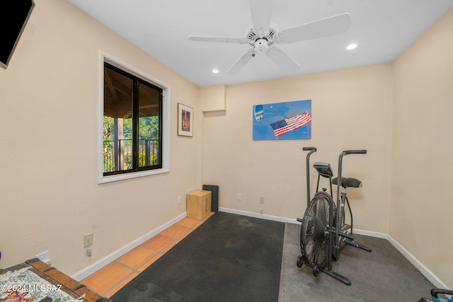 exercise area featuring ceiling fan and light tile patterned floors