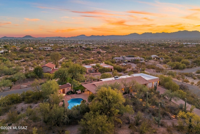 aerial view at dusk featuring a mountain view