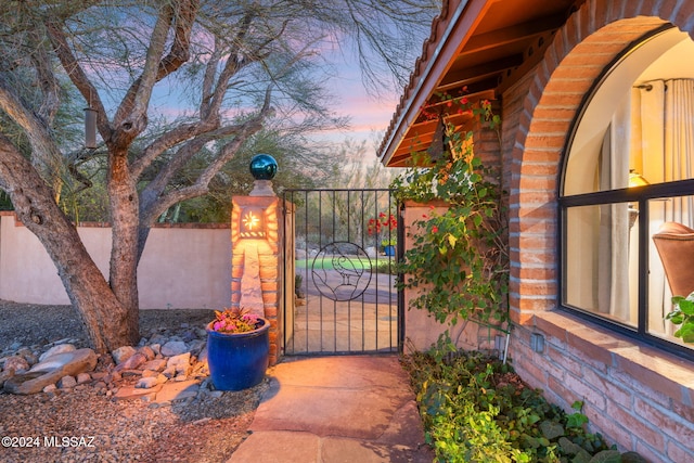 view of gate at dusk