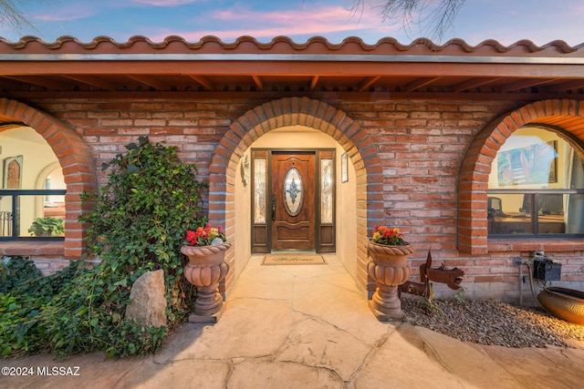 view of exterior entry at dusk