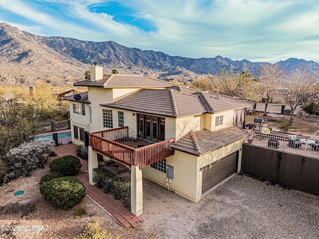 view of front of property with a garage and a mountain view