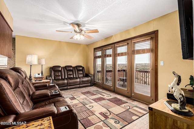 living room featuring a textured ceiling and ceiling fan