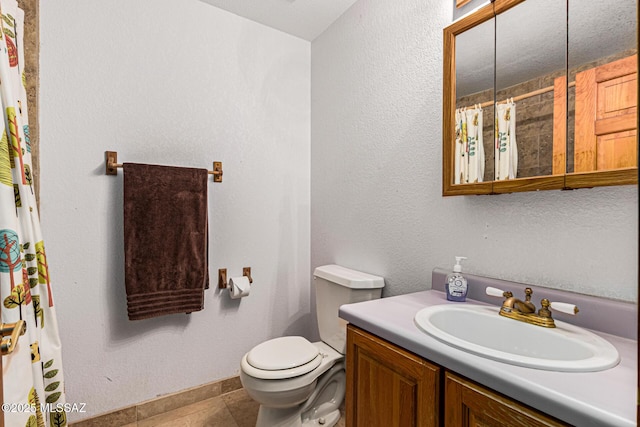 bathroom featuring vanity, tile patterned floors, and toilet