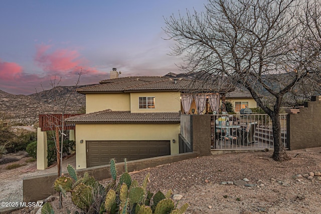 view of front facade featuring a garage and a mountain view