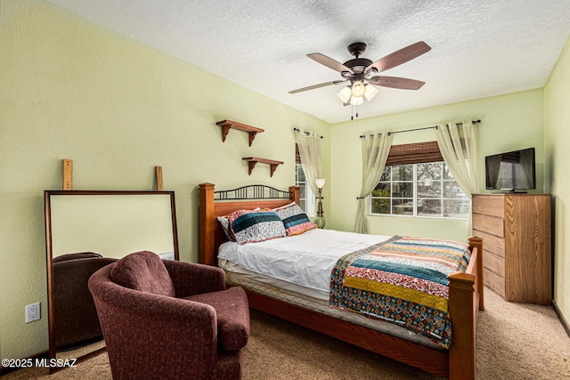 carpeted bedroom with ceiling fan and a textured ceiling