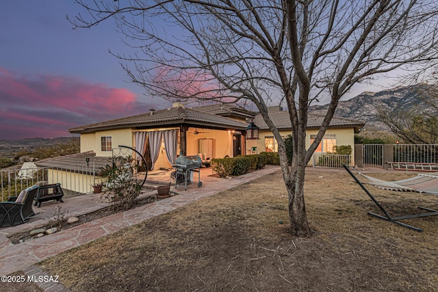 view of front of property featuring a patio and a mountain view