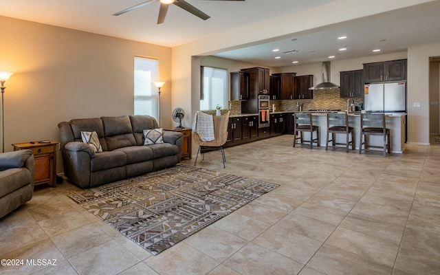 living room featuring ceiling fan and light tile patterned floors