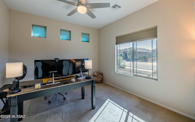 carpeted office space featuring ceiling fan