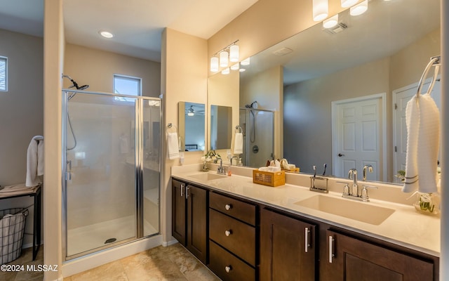 bathroom with tile patterned flooring, vanity, and walk in shower