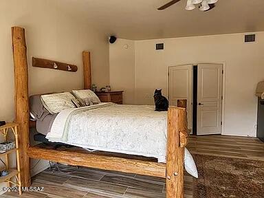 bedroom featuring dark hardwood / wood-style flooring and ceiling fan