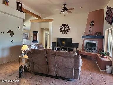 living room featuring tile patterned floors and ceiling fan