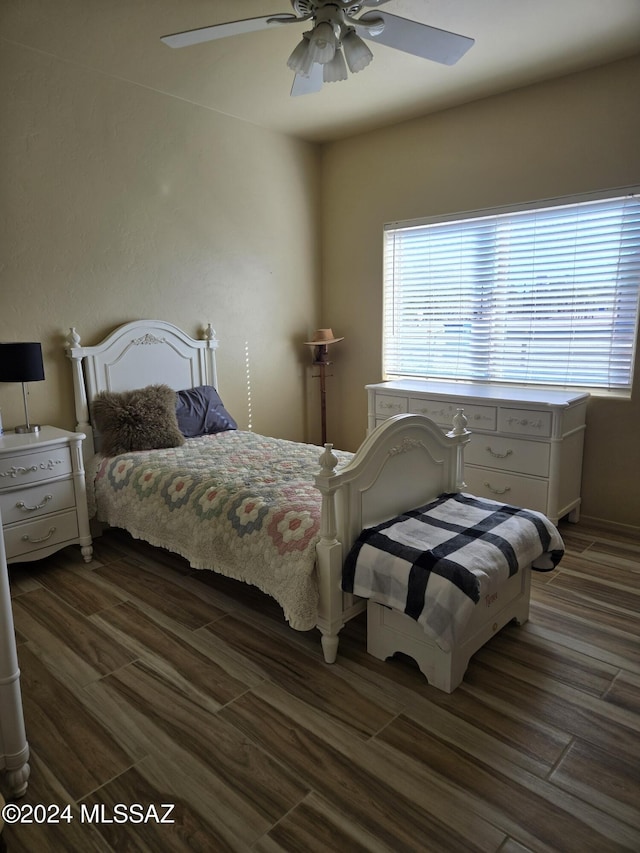 bedroom featuring ceiling fan and dark wood-type flooring