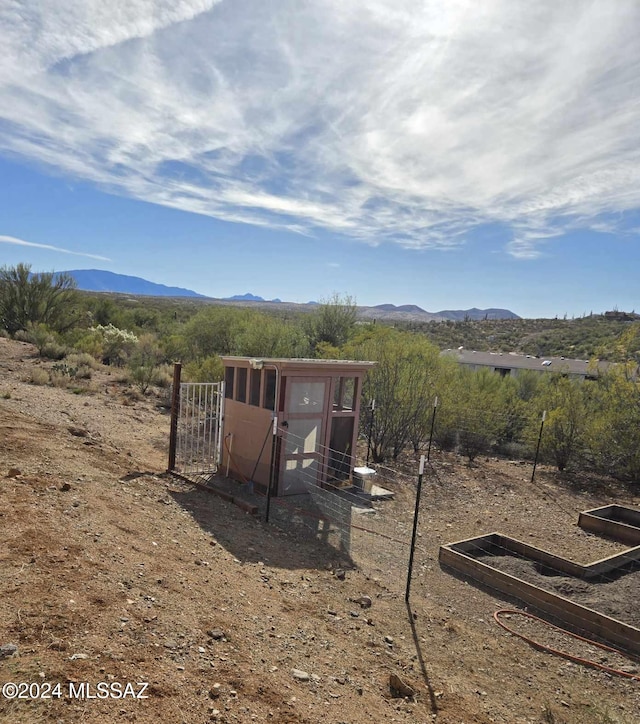 exterior space featuring a mountain view and an outdoor structure