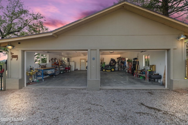 view of garage at dusk