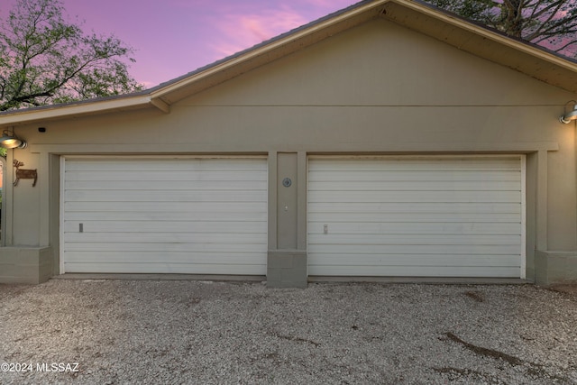 view of garage at dusk