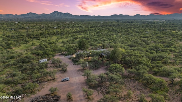 aerial view at dusk featuring a mountain view