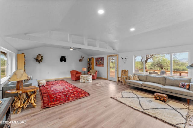 living room with vaulted ceiling with beams, a healthy amount of sunlight, and hardwood / wood-style flooring