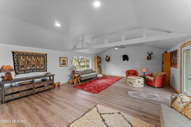 living room with light wood-type flooring, vaulted ceiling with beams, and ceiling fan