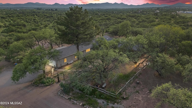 aerial view at dusk featuring a mountain view