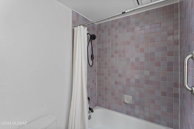 bathroom featuring toilet and shower / bathtub combination with curtain