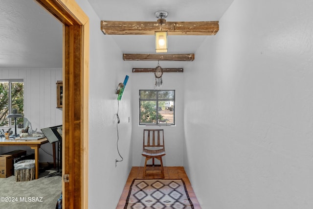 interior space featuring vaulted ceiling with beams, wooden walls, and tile patterned flooring