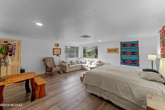 bedroom with hardwood / wood-style floors