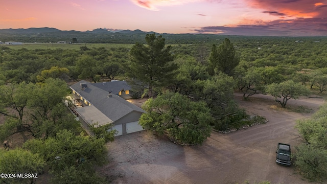 aerial view at dusk featuring a mountain view