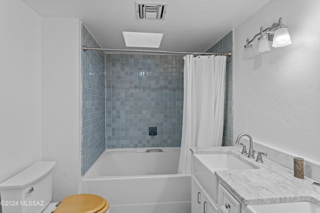 full bathroom with vanity, a skylight, toilet, and shower / bath combo with shower curtain