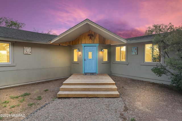 view of exterior entry at dusk