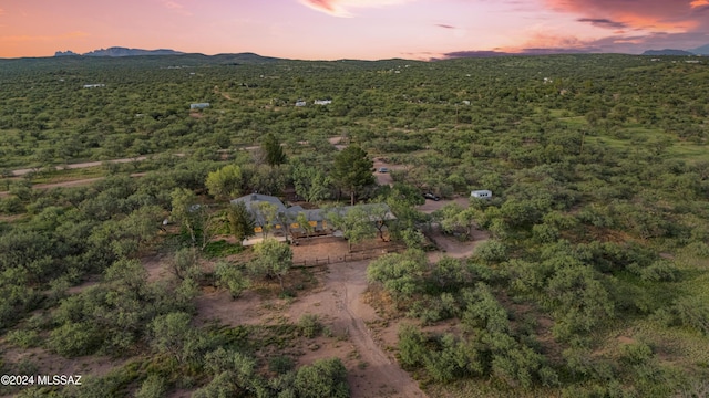 aerial view at dusk featuring a mountain view