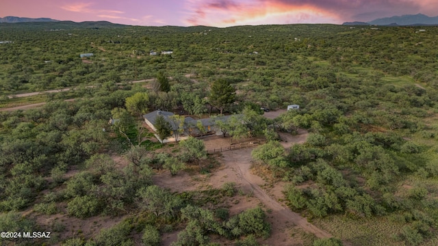 aerial view at dusk featuring a mountain view