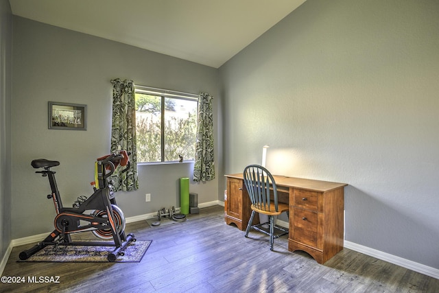 home office featuring dark hardwood / wood-style flooring and lofted ceiling