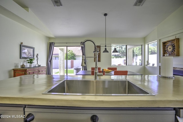 kitchen with plenty of natural light, sink, and vaulted ceiling