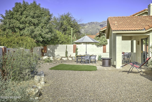 view of yard featuring a mountain view and a patio