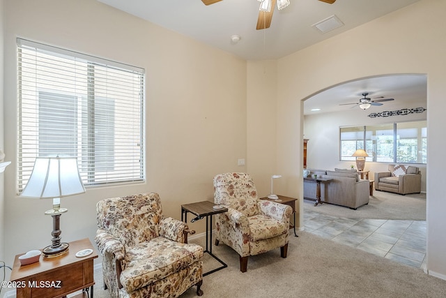 sitting room featuring light carpet and ceiling fan