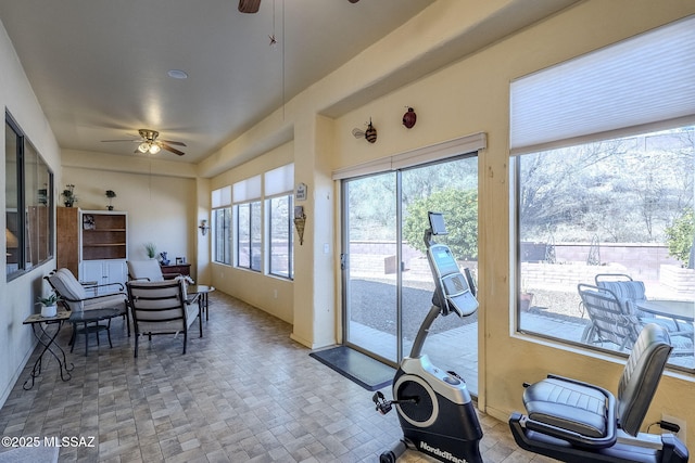 sunroom / solarium featuring a wealth of natural light and ceiling fan