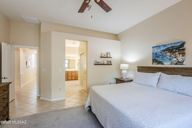 bedroom featuring light tile patterned flooring, ensuite bathroom, and ceiling fan